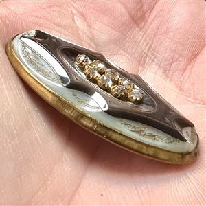 Late 19th c. Carved pearl button in metal with oval center of pastes. 