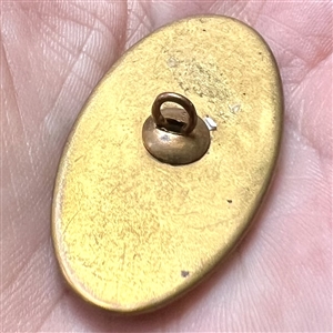 Late 19th c. Carved pearl button in metal with oval center of pastes. 