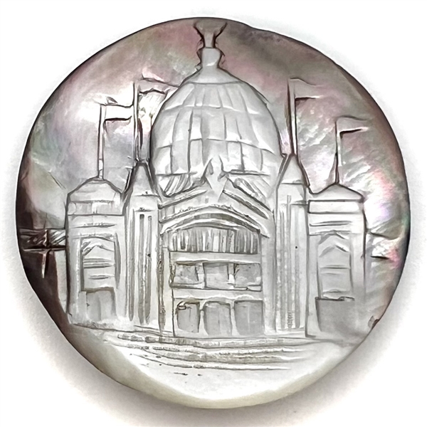 Cameo carved smoky pearl button of a domed building with flags flying.
