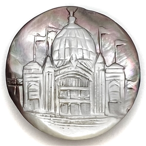 Cameo carved smoky pearl button of a domed building with flags flying.