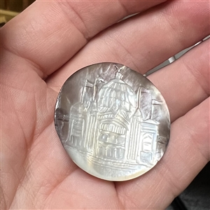 Cameo carved smoky pearl button of a domed building with flags flying.