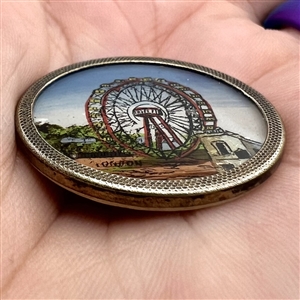 Painting under glass set in metal of “The Great Wheel. 