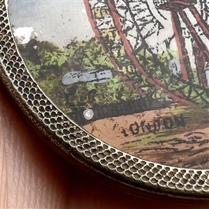 Painting under glass set in metal of “The Great Wheel. 