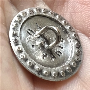 Enamel on white metal button of a woman in hat with border of faceted cut-steels.