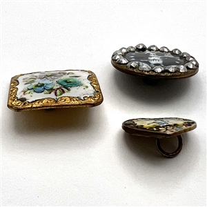 Three fun enamel buttons.