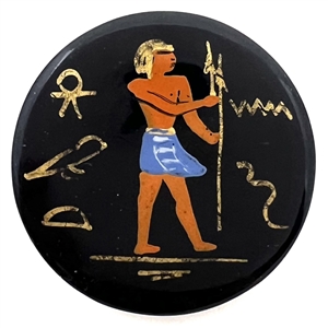 Painted casein button of an Egyptian man with symbols. 