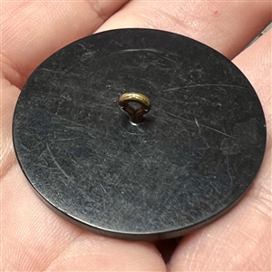 Painted casein button of an Egyptian man with symbols. 