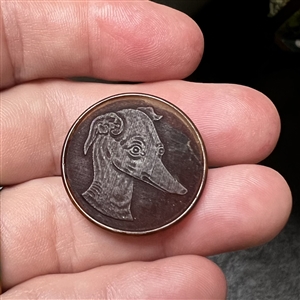 Transparent dyed horn sporting button of a whippet.