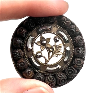 Lovely brass button with cut steels, wood and plant life center with open work.