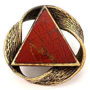 Couture button of triangular red Jasper with a “möbius" strip border of brass.