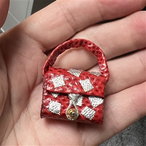 Adorable leather studio button of a purse by Nancy Dubois.