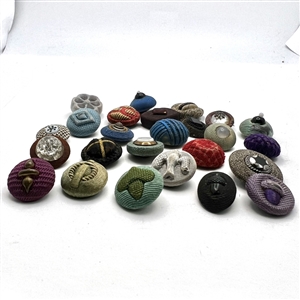 Twenty five Div I fabric buttons including fancy tops.