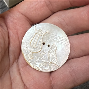 Pearl button of music - a harp, musical staff with notes and a singing bird.