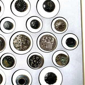 Competition/display card of twenty five Div I black glass buttons with lusters. 