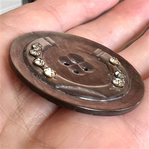Cameo carved pearl button of a horseshoe with pastes.