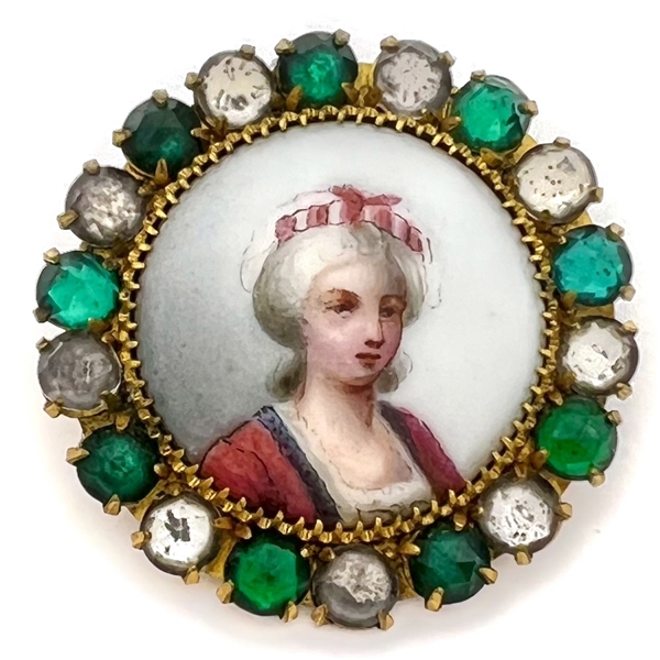 A 19th c. Painted porcelain button of a woman set in metal with boarder of pastes.