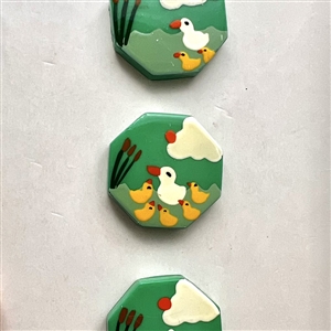 Set of five Marie Christine Pavone buttons of mamma duck and ducklings on original store card.