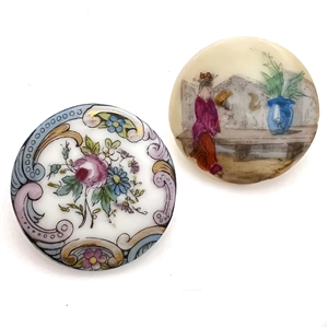 Two painted porcelain buttons.