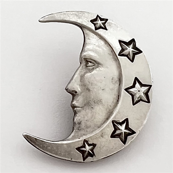 Silver button of man in the moon crescent face and stars.