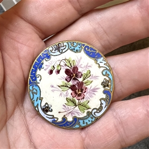 A 19th c. Enamel button of pansies with a champlevé border. 