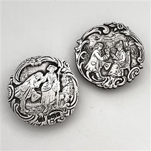 Two silver buttons of courting couples.