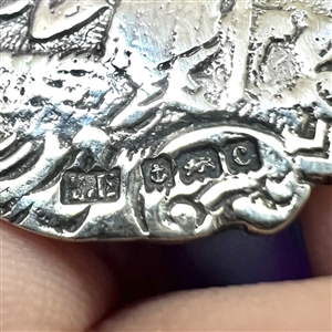 Two silver buttons of courting couples.