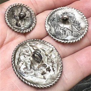 Three silver buttons of people doing things.