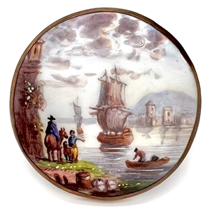Painted porcelain button of a bay scene set in metal.