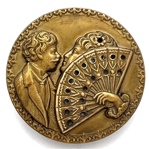 Stamped brass button of “The Stolen Kiss."
