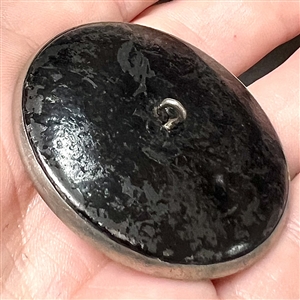 Brass button of “Chase of Pleasure - a schoolboy, slate in hand about to swat a fly.