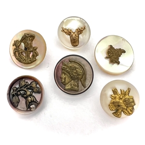 Six small pearl buttons with brass escutcheons. 