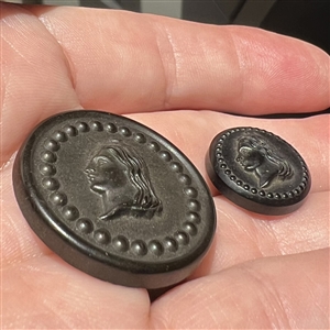 Two “Liberty Head Goodyear rubber buttons in two sizes.