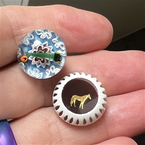 Two glass studio paperweight buttons by John Gooderham.