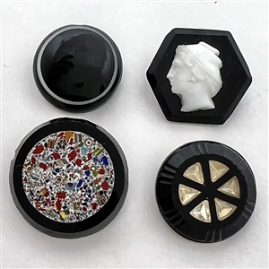 Four black glass buttons. 