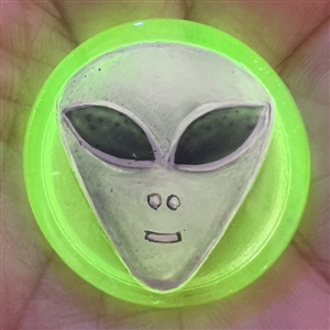 Uranium yellow glass button of an alien head.