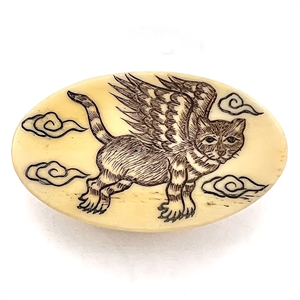 Natural material button of a flying cat. 