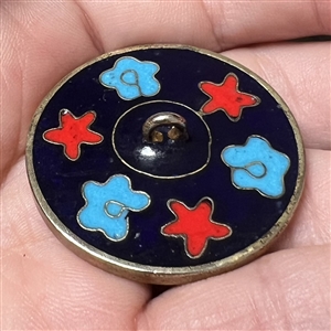 Modern cloisonné button of a bird among flowers. 