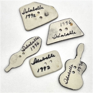 Five ceramic studio buttons of music theme by Idabelle Byer.