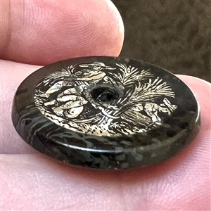 “The Reapers composition whistle-hole button with an inset of crystalized tin.