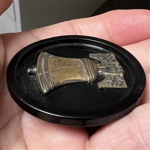 Brass over celluloid Liberty Bell button. 