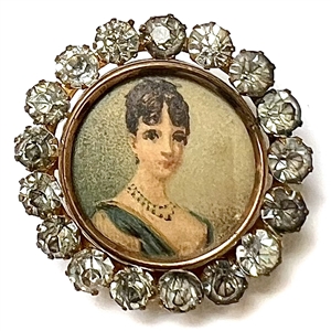 Lithograph under glass set in metal with paste border of a beautiful woman.