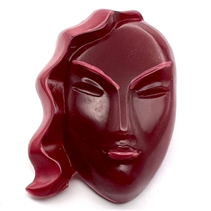 Vintage plastic button of a realistic womans face.