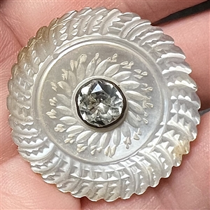 An 18th c. Carved pearl button with faceted paste center.