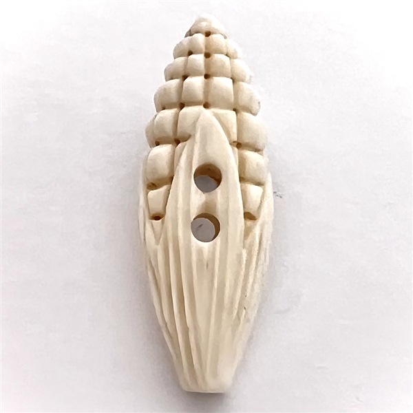 Carved natural material button of corn.