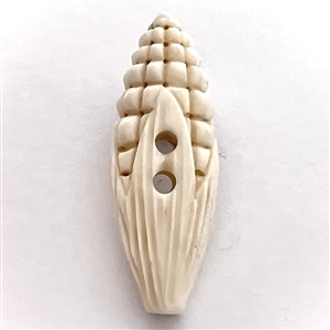 Carved natural material button of corn.