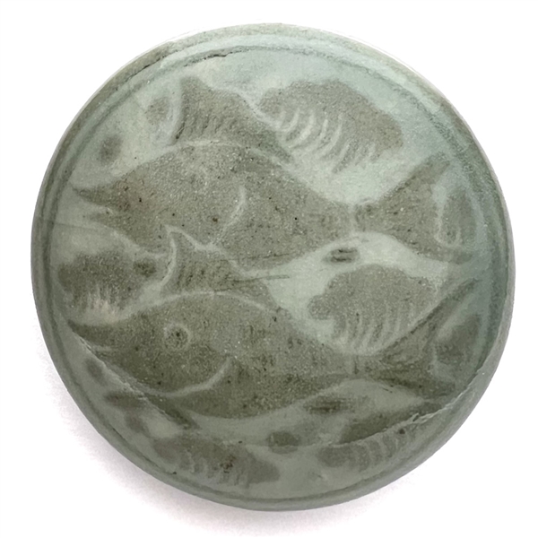 Glazed pottery obi-dome of swimming fish.