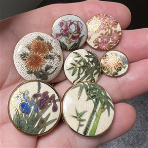 Seven Satsuma buttons of flowers and bamboo.