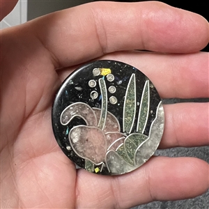Design in plastic (DIP) button of plant life.