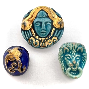Three ceramic buttons of assorted subjects. 