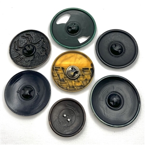 Seven vintage celluloid  buttons (one-piece '30's) mostly sport themes. 